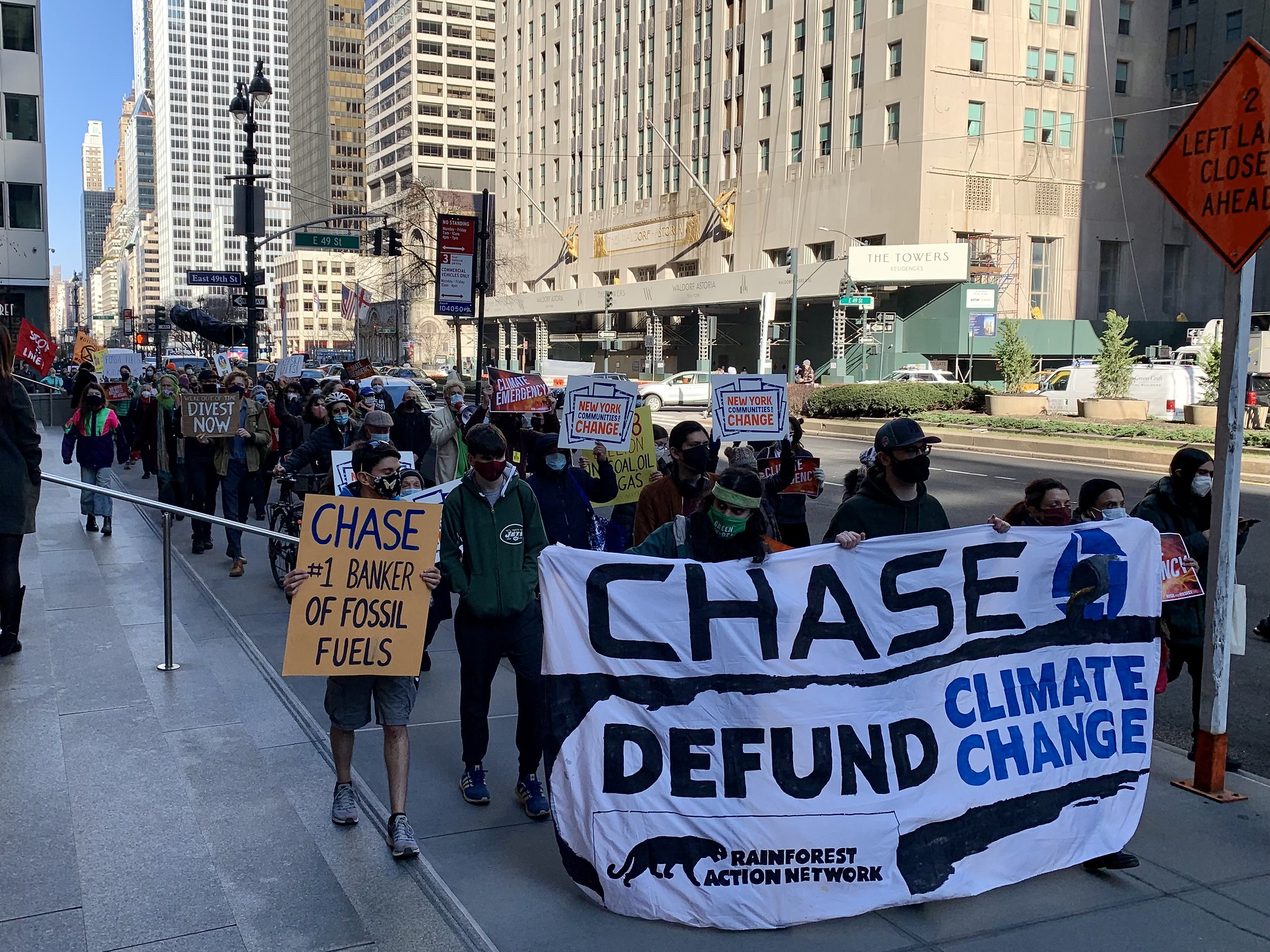 protest with banner chase defund climate change