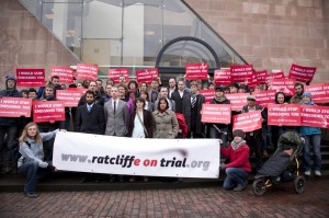 Defendants and supporters gather outside court for the first day of the trial