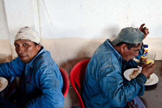 Two oil workers eating in a cafeteria in Taracoa.