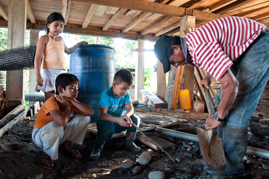 Nelson Alvarado digs up crude oil from beneath his home.