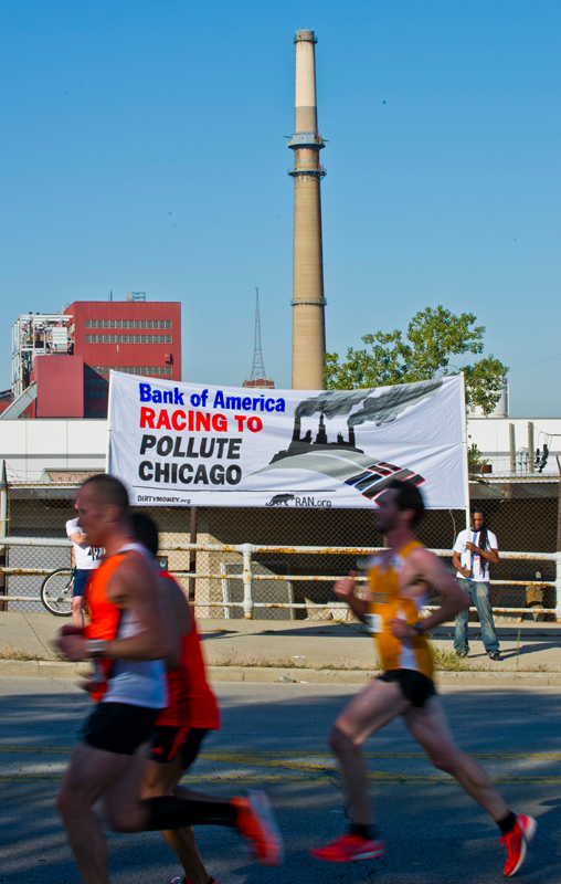 Activists hold up a banner reading 