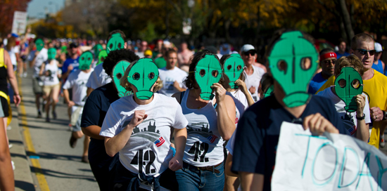 Activists run in the Bank of America-sponsored Chicago marathon wearing gas masks.