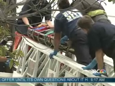 Firefighters take injured woman down a ladder