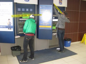 Marking the ATM early in the morning before the bank opens.